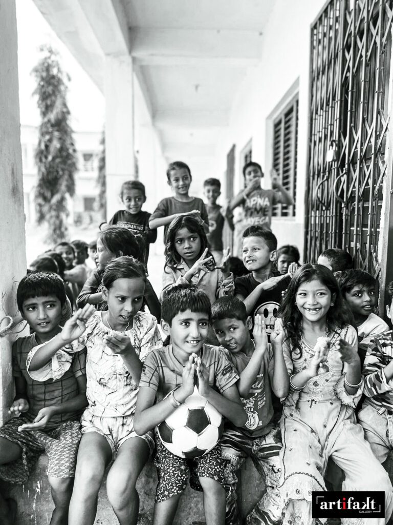 artifakt gallery- children in Nepal students with a boy holding a soccer ball